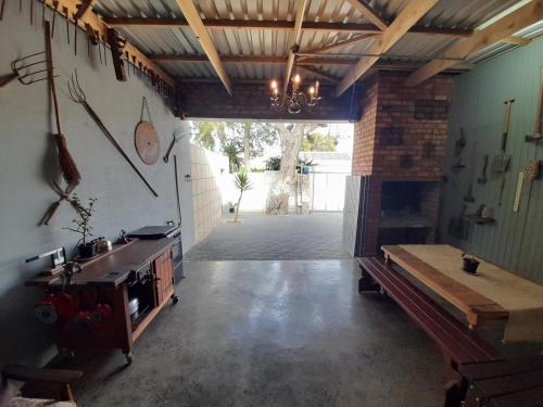 a kitchen with a table and a stove in a room at The Regiment Self Catering Accommodation in Welgemoed