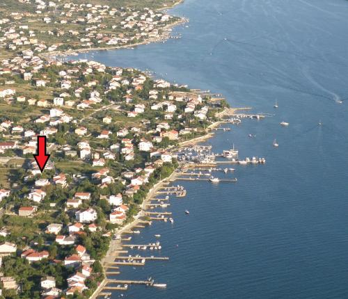 an island with houses and boats in the water at Villa Summer Escape In Barbat Mit Garten Und Aussicht in Barbat na Rabu