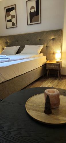 a hotel room with a bed and a table with a candle at ZŁOCKIE HILL spa in Muszyna