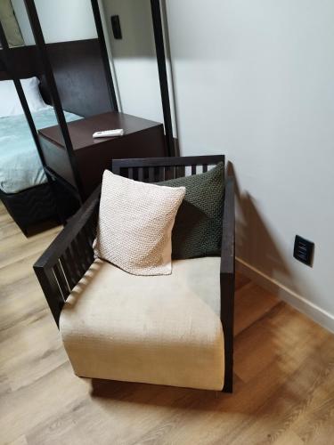 a chair with pillows on it in a room at Smart mundurucus 1427 in Belém