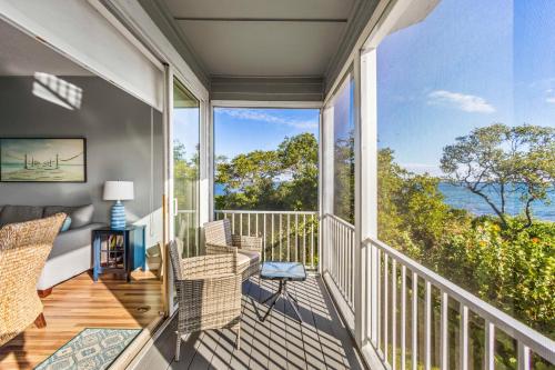 a balcony with chairs and a view of the ocean at Cedars East #822 in Longboat Key