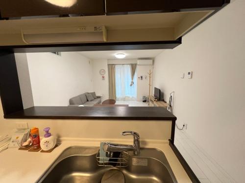 a kitchen with a sink and a mirror above it at 花園之家 in Osaka