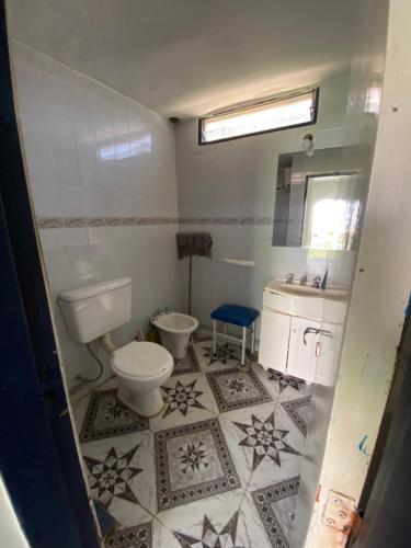 une salle de bain avec des toilettes blanches et un lavabo dans l'établissement Apartamento El Gauchito en Cosquin, à Cosquín