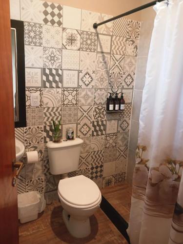 a bathroom with a toilet and a sink at Departamento Perico Jujuy in Perico