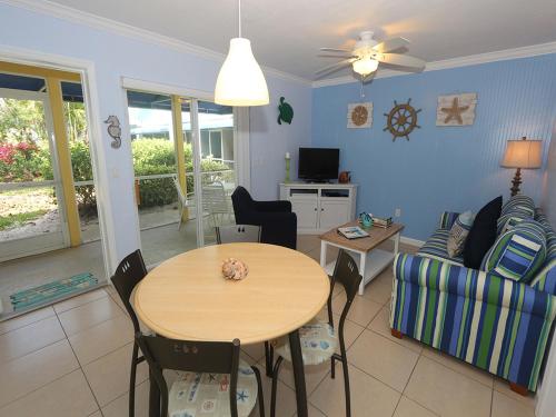 a living room with a table and a couch at Silver Sands #232 in Longboat Key