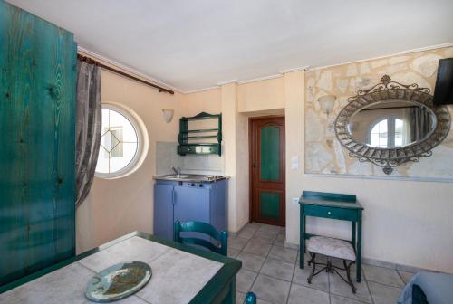 a dining room with a table and a mirror at Castle Suites Hotel in Plataniás