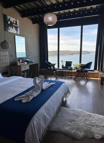 a bedroom with a bed with a large window at Marina Boutique Hotel Istanbul Airport in Karaburun