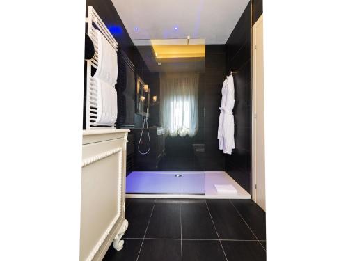 a bathroom with a shower and a tub in a room at Relais Sassa al Sole in San Miniato