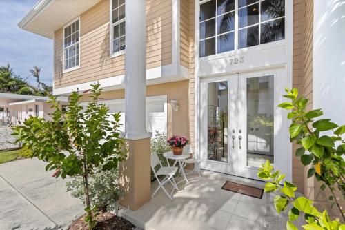 una casa con un portico anteriore con tavolo e sedie di Marbury Lane a Sister Keys