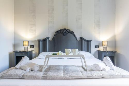 a bed with a table with towels on it at La casa di Minù by Houset in Monza