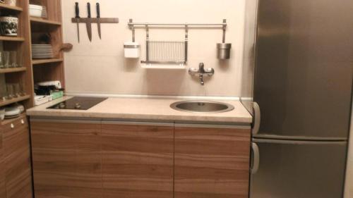 a kitchen with a sink and a refrigerator at Stone House Petra in Perast