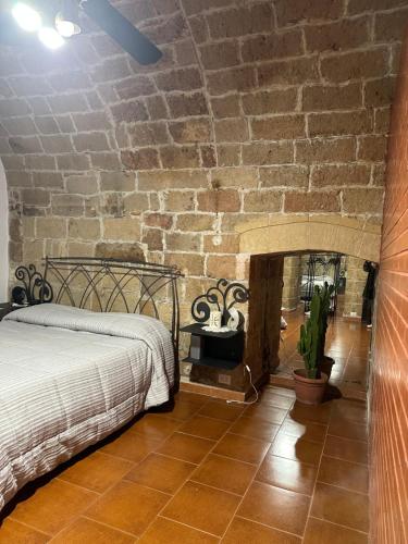 a bedroom with a bed and a brick wall at casa Carlos in Bari Palese