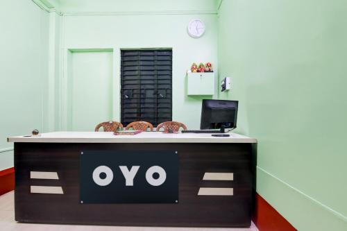 an office with a desk with an ovo sign on it at Hotel O Sampad in Baharampur
