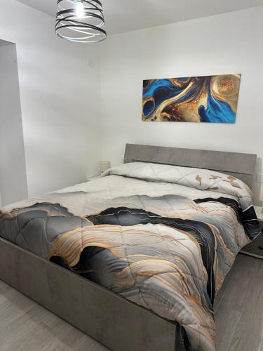 a bed in a bedroom with a painting on the wall at Residenza Aurora in Isernia
