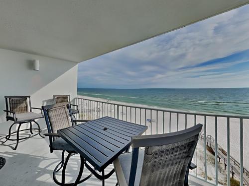 a balcony with a table and chairs and the ocean at Perdido Skye #54 in Perdido Key