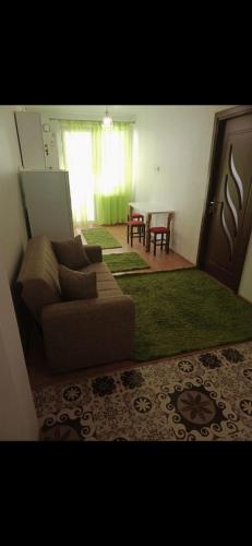 a living room with a couch and a table at Apartament LUXURY Cluj in Floreşti