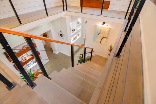 an overhead view of a staircase with wood and metal railings at Tesoro en la Colina in Palmetto Bay