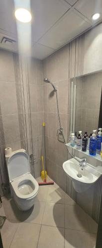 a bathroom with a toilet and a sink at SARA Apartment in Dubai
