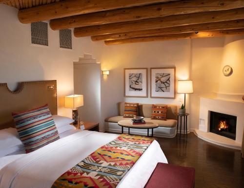 a bedroom with a bed and a fireplace at Rosewood Inn of the Anasazi in Santa Fe