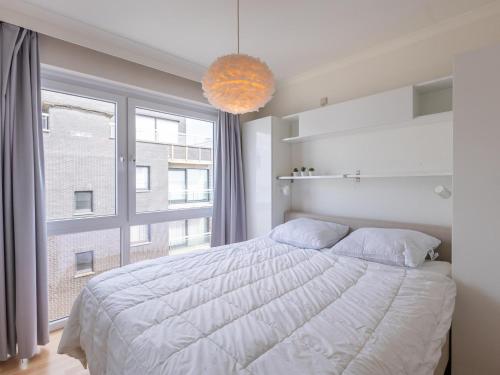 Un dormitorio con una cama grande y una ventana grande. en Kwintebank - 0904, en Miami Wijk