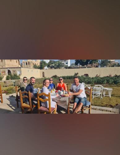 a group of people sitting around a table at Leyla Eco Resort Queen Suites in Luxor