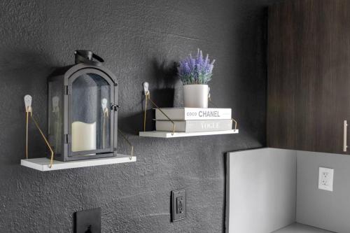 a bathroom with two shelves on the wall with a clock at Unit 1 Cozy 1BR Apt with Parking in Miami