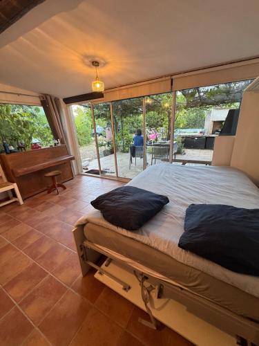 a bedroom with a bed with pillows on it at Studio with pool and quiet, non-shared garden, 1 lit double in Gardanne