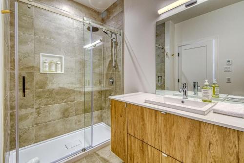 a bathroom with a sink and a shower at Verbier Condo in Tremblant with Mountain Views - 105 Verbier in Mont-Tremblant