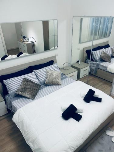 a bedroom with a large white bed with black crosses on it at Treviso Home Chic in Treviso