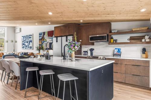 a kitchen with a large island in the middle of a room at Luxury 4BR with Hot Tub Mtn Views 10Min Walk to DT in Canmore