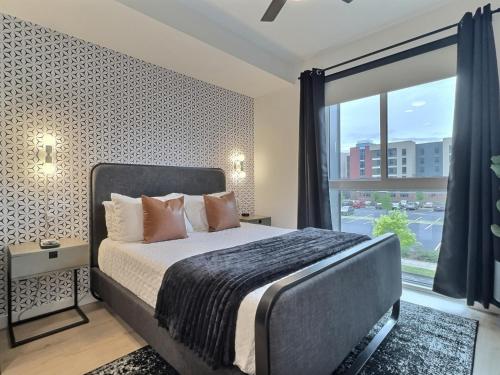 a bedroom with a bed and a large window at Cozy Bham Getaway, Modern Stay Near UAB in Birmingham