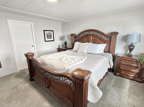 a bedroom with a large bed with a wooden frame at Walker Ridge in Montrose