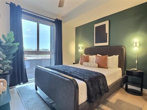 a bedroom with a bed and a large window at Downtown Vibes, Gym, Walk to Everything Fun in Birmingham