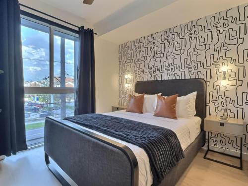 a bedroom with a bed and a large window at Urban Studio, Walk to UAB and Railroad Park in Birmingham