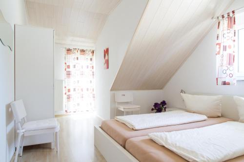 a bedroom with two beds in a attic at Pension Sieg in Rust