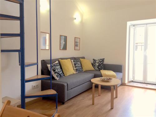 a living room with a couch and a table at Apartments Center Lisboa in Lisbon
