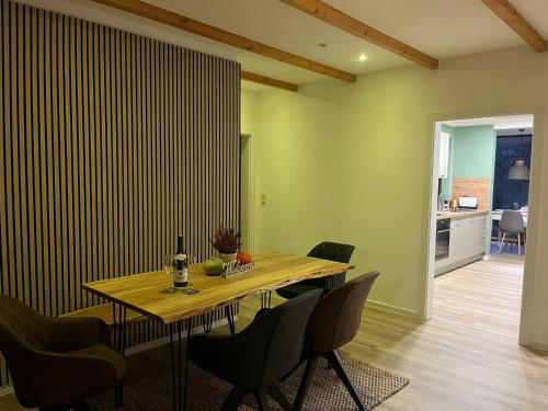 a dining room with a wooden table and chairs at Gemütliche Heidschnucke in Soltau