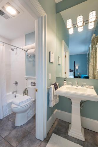 a bathroom with a sink and a toilet at Saratoga Arms Hotel in Saratoga Springs