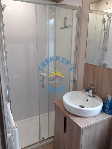 a bathroom with a sink and a shower at Trekkers Rest, Brigham, Cockermouth, Cumbria in Cockermouth