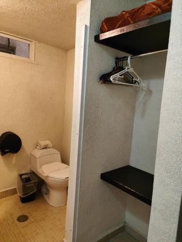 a bathroom with a toilet in a room at Hotel 1988 Guanajuato in Guanajuato