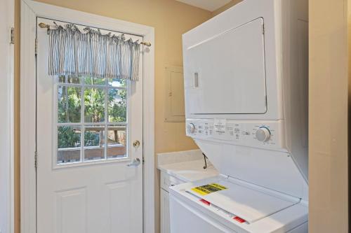 a kitchen with a white stove top oven next to a window at GL1205: 1205 Greenslake in Kiawah Island