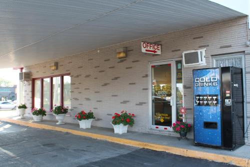 a building with a cold pharmacy with flowers in front of it at Elect Inn 5 in Cornwall