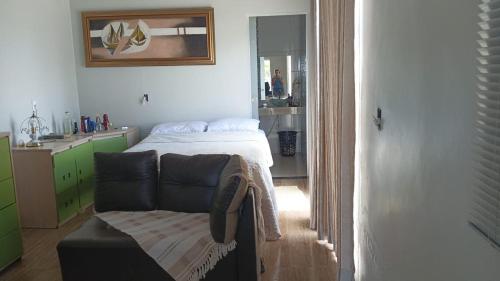a bedroom with a bed and a couch in it at Rancho Serra do Ouro in Alexânia