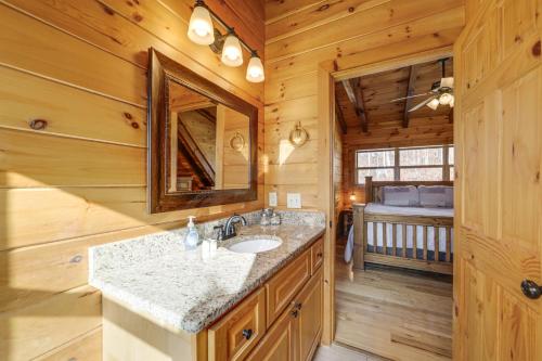 a bathroom with a sink in a log cabin at Elevated Cabin Bordering Smoky Mountain Nat'l Park in Bryson City
