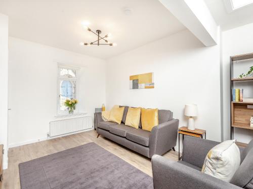 a living room with a couch and a table at Dove Cottage in Inverness