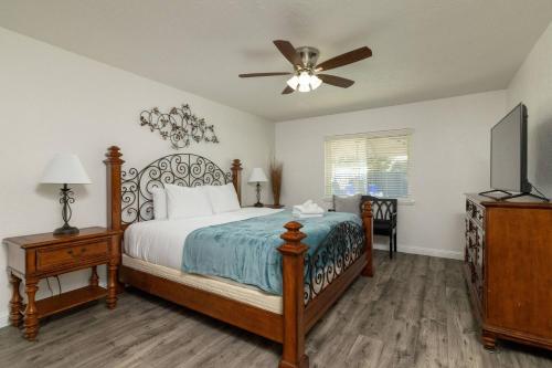 a bedroom with a bed and a ceiling fan at Private Pool - Game Room - Backyard TV - Fenced Yard in Plano