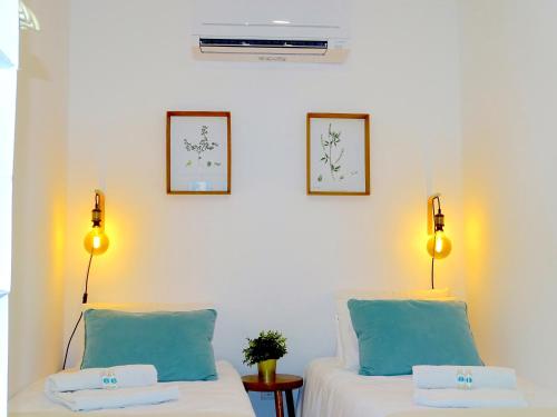 two beds in a room with blue and white at Apartments Center Lisboa in Lisbon