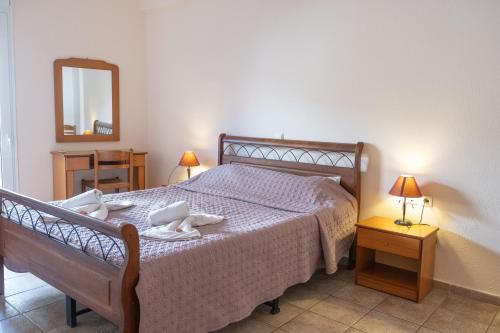 a bedroom with a bed with towels on it at El Greco Apartments in Istron