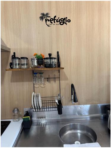 a kitchen with a sink and a counter top at Refúgio Vibe do Mar in Barra Velha