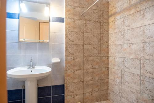 a bathroom with a sink and a mirror at El Greco Apartments in Istron